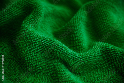 Green towel texture background. Low key.