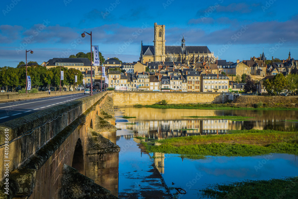 View on the gothic St Cyr Ste Juliette cathedral and the city of Nevers from the Loire River bridge