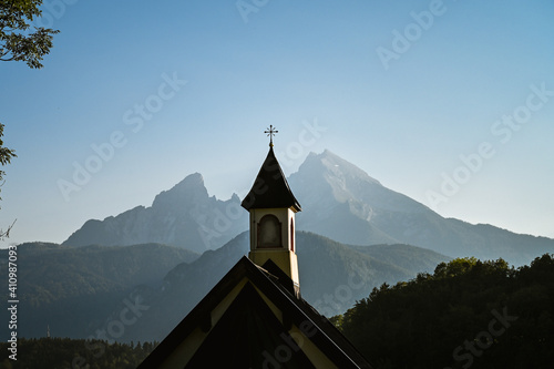 Roof and small tower of the Kirchleitn chapel in front of an amazing alpine panorama that shows  the Watzmann summit in the Bavarian Alps. photo