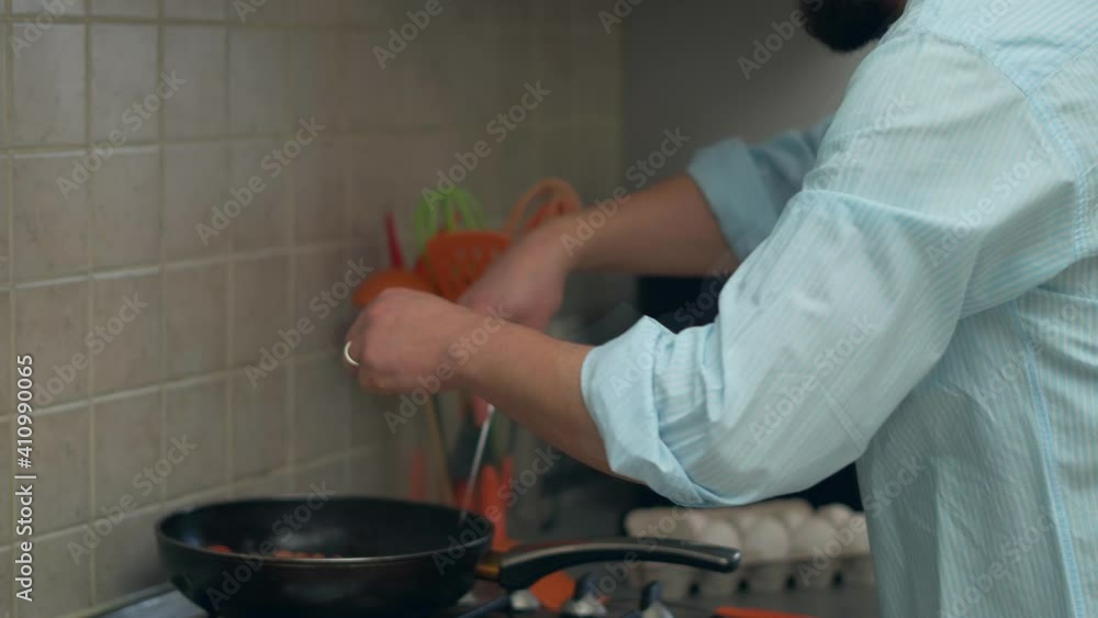 Bearded Man in kitchen cooking dish Bearded Man in kitchen cooking dish