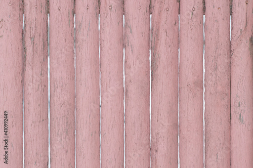 The background of the fence is pink old wooden.