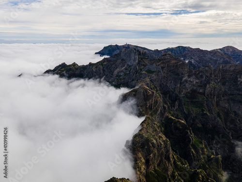 Fototapeta Naklejka Na Ścianę i Meble -  View of beautiful mountain landscape above the clouds of Madeira Island - Green mountain landscape with view above the sky
