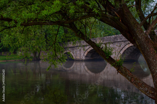 Roman bridge reflection on river Bosna in Sarajevo photo