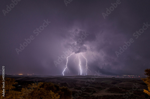 Beautiful night sky with lightning and thunderbolts during a thunderstorm in the countryside