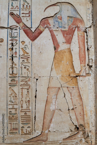 A wall relief of god Thoth, the patron of writing, with human body and Ibis head on the wall of the temple in Abydos, Egypt
