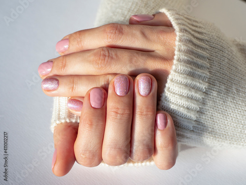 Fashionable pink manicure design in the hand.