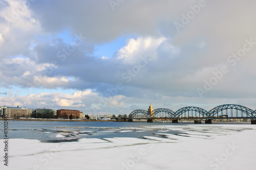 riga, city panorama, frozen river and snow in the foreground