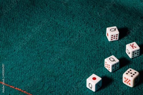 poker dice on a green background,poker concept. photo