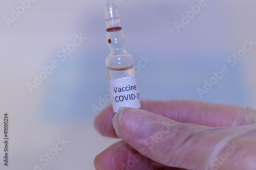 Medical doctor or laborant holding tube with nCoV Coronavirus vaccine