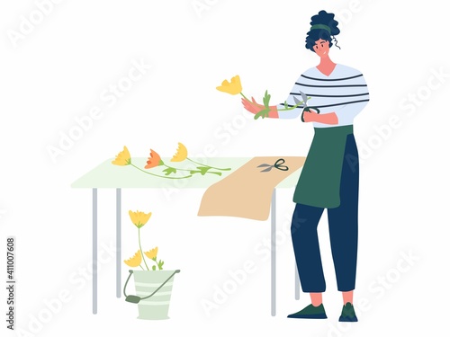 Woman compose bouquet on table. Forist shop or store.