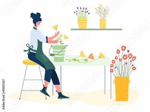 Woman compose bouquet on table. Forist shop or store.