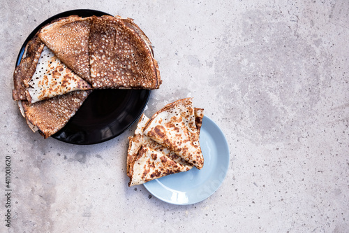 A few pancakes on a light grey background. Top view. Flat lay. photo