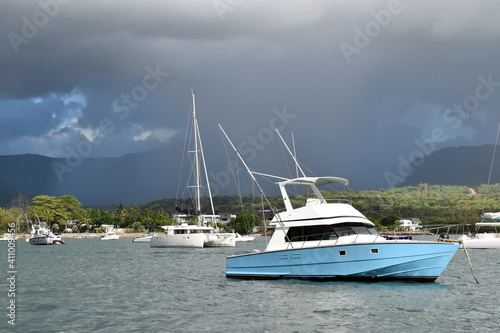 Mauritius dated 5th of Feb 2021. Leisure boats moored in a tranquil bay with in the background a terrible storm approaching.