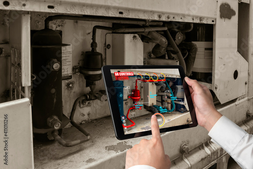 Engineer use augmented reality software in smart factory production line with automated application . Futuristic machinery in working in concept of Industry 4.0 or 4th industrial revolution. photo