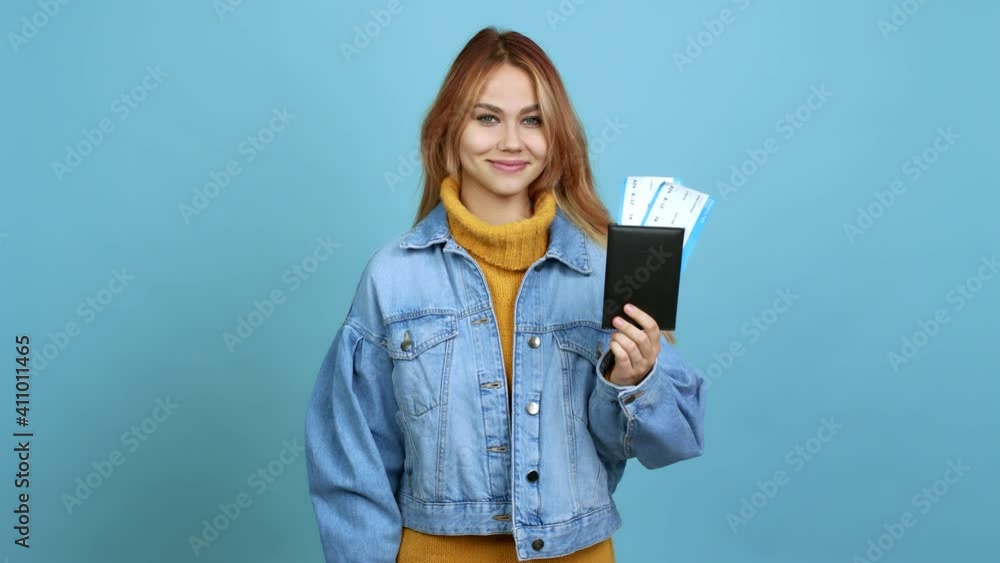 Teenager girl holding a passport with happy face over isolated background Teenager girl holding a passport with happy face over isolated background