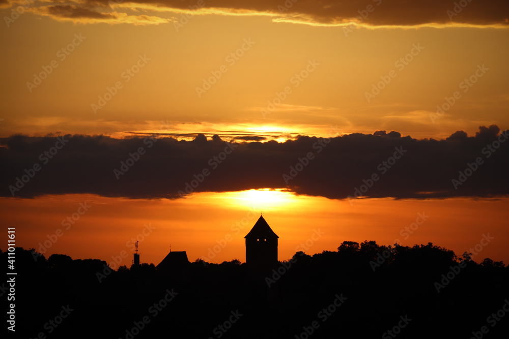Orange sunset skyline silhouette of a landmark castle