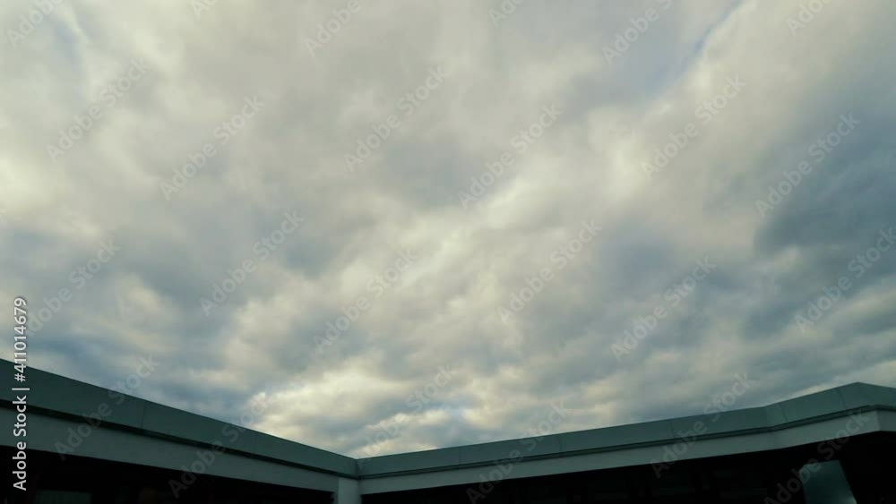 Dramatic clouds flying over the rooftop. Storm is coming. Dramatic clouds flying over the rooftop. Storm is coming.