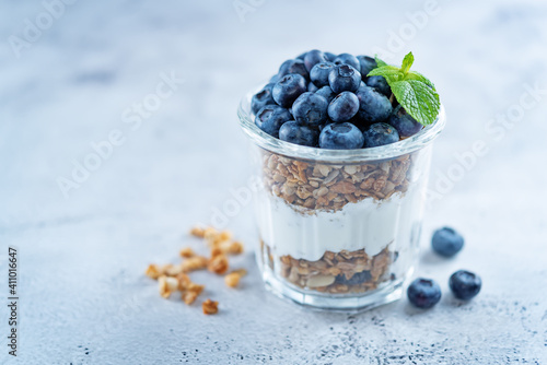 Blueberry Greek yogurt granola parfait in a glass
