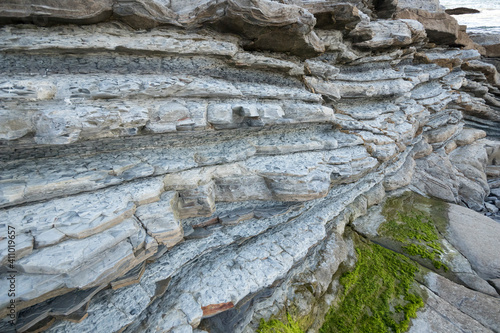 Closeup image of geological formation flysch made of stone sheets in horizontal.