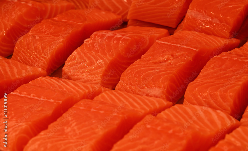 Raw salmon fish filet steaks on ice