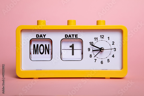 Retro electronic alarm clock and analog flip calendar. Retro design from 60s 70s home interior. Bright yellow color