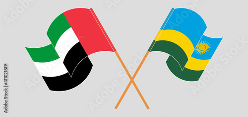 Crossed and waving flags of the United Arab Emirates and Rwanda
