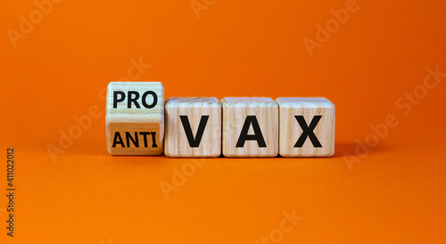 Pro-vax or anti-vax symbol. Turned a cube, changed words 'anti-vax' to 'pro-vax'. Beautiful orange background. Copy space. Business, medical covid-19 pro-vax or anti-vax concept. photo