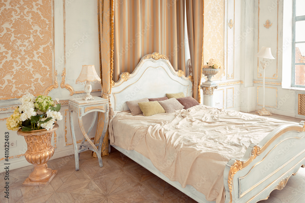 very rich interior of the apartment with golden decorations on the walls in the Baroque style and luxury furniture with gold paint. very rich interior of the apartment with golden decorations on the walls in the Baroque style and luxury furniture with gold paint.