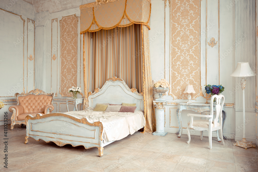 very rich interior of the apartment with golden decorations on the walls in the Baroque style and luxury furniture with gold paint. very rich interior of the apartment with golden decorations on the walls in the Baroque style and luxury furniture with gold paint.