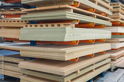 Construction sheet materials stored on cantilever rack in joinery workshop. photo