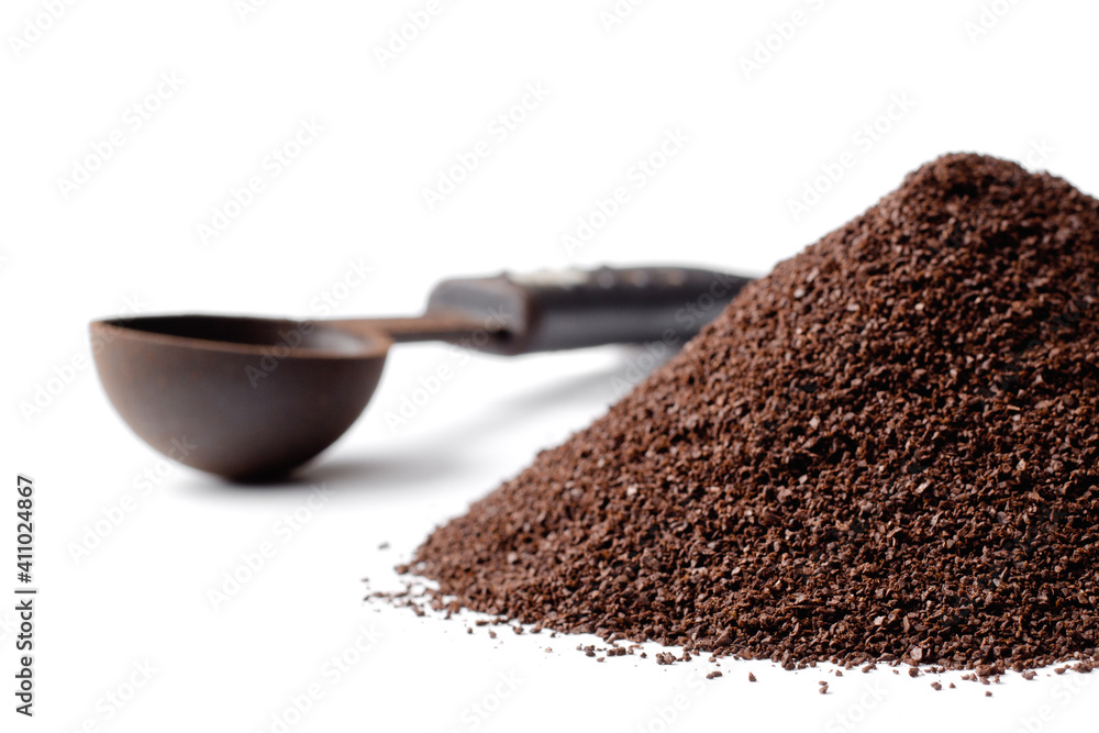 Coffee grounds and scoop on white with copy space Coffee grounds and scoop on white with copy space