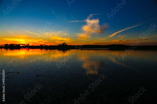 Reflection of orange and blue sky over the lake during sunset in Florida.  © kmhphotovideo