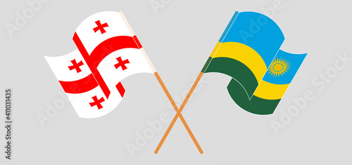 Crossed and waving flags of Georgia and Rwanda
