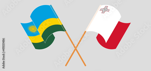 Crossed and waving flags of Rwanda and Malta