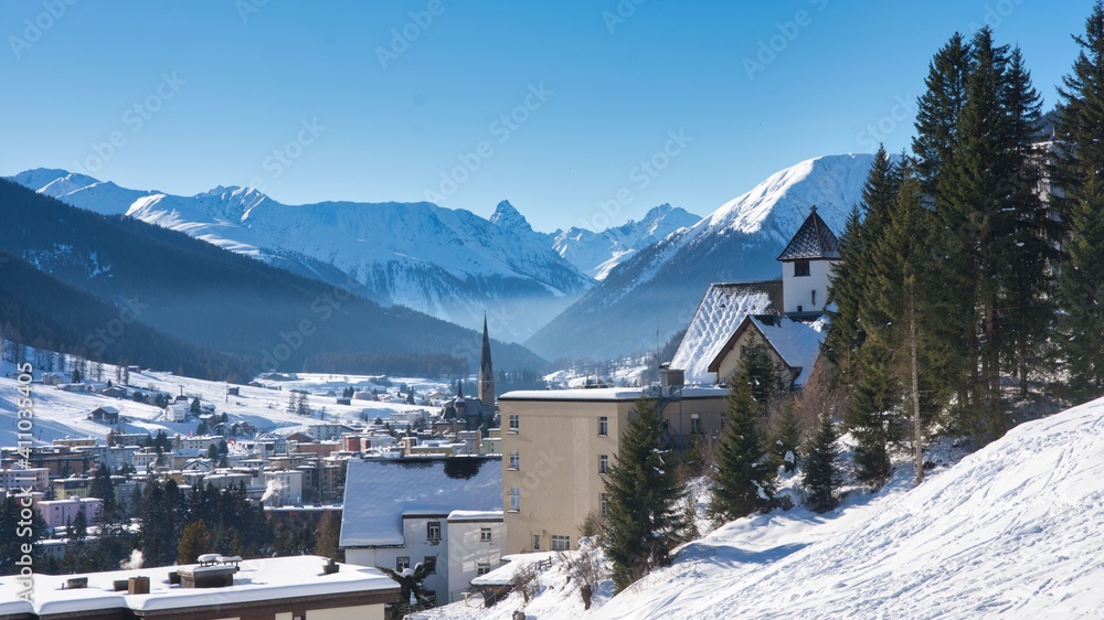 Davos Graubunden Switzerland. Highest city in Europe, Winter landscape with a view of the Alps and a church tower