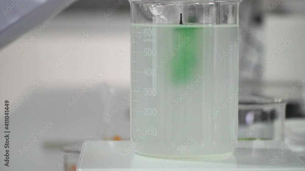 mixing chemicals in laboratory, testing and dripping test fluid in close up mixing chemicals in laboratory, testing and dripping test fluid in close up