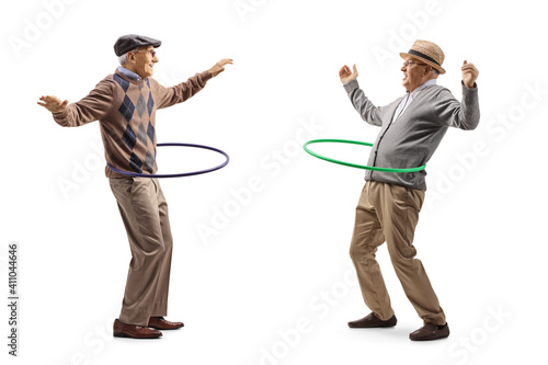 Happy elderly men spinning hula hoops