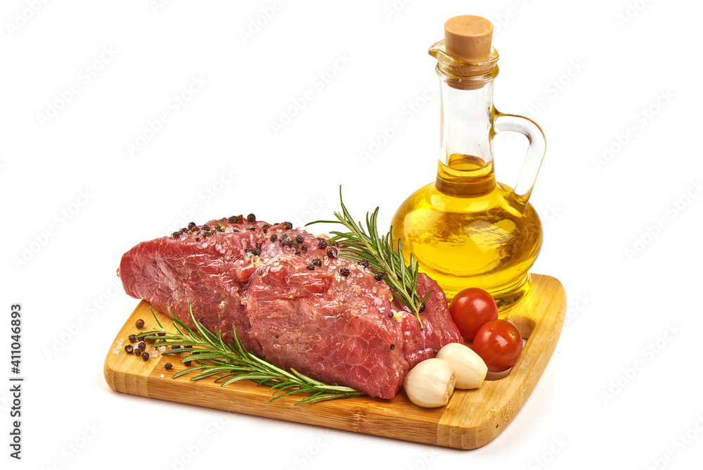 Raw beef meat with spices on cutting board, isolated on white background Raw beef meat with spices on cutting board, isolated on white background