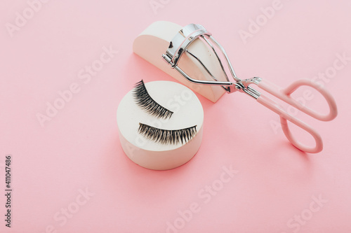 Obraz na plátně Fashion fake false eyelash with curler on pink background