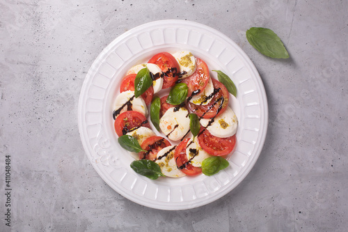 Caprese salad. Italian famous salad with fresh tomatoes, mozzarella cheese and basil