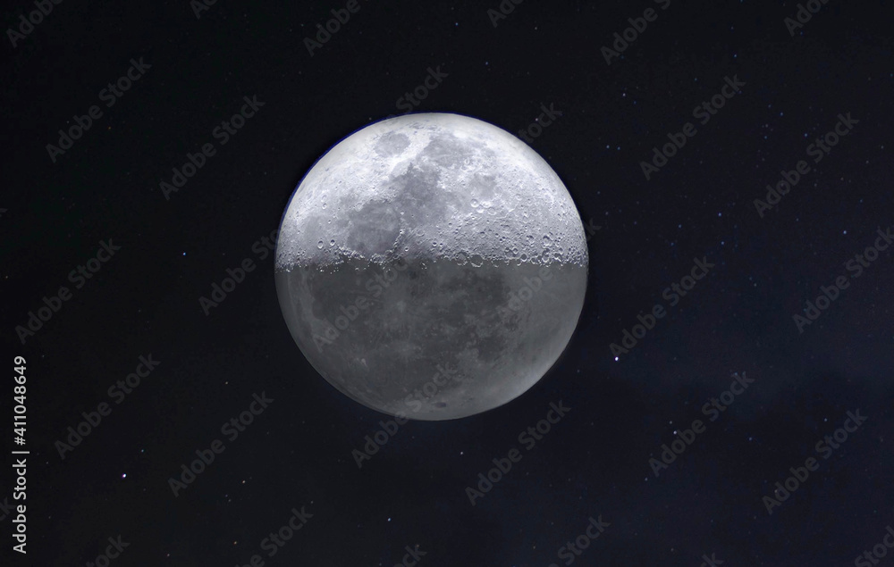 Moon with stars and clouds in background 