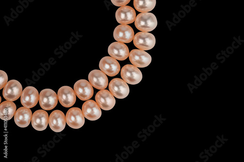 two strings of natural pink pearls, isolate on a black background