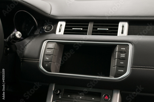 Modern car dashboard with control buttons and touch screen multimedia system. Interior detail.