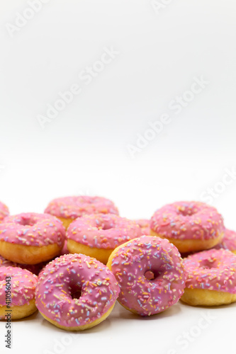 Wallpaper Mural Group of sweet dessert pink donuts on a white background with copy space above for own text Torontodigital.ca