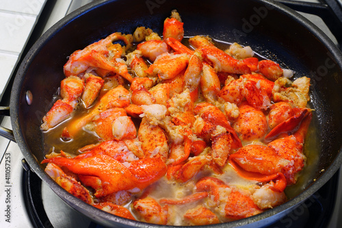 Sauteeing lobster meat in a pan