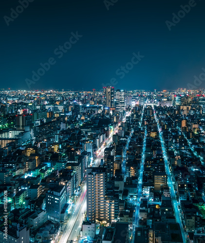 Futuristic Aerial View of City Rooftops at Night in Tokyo, Japan