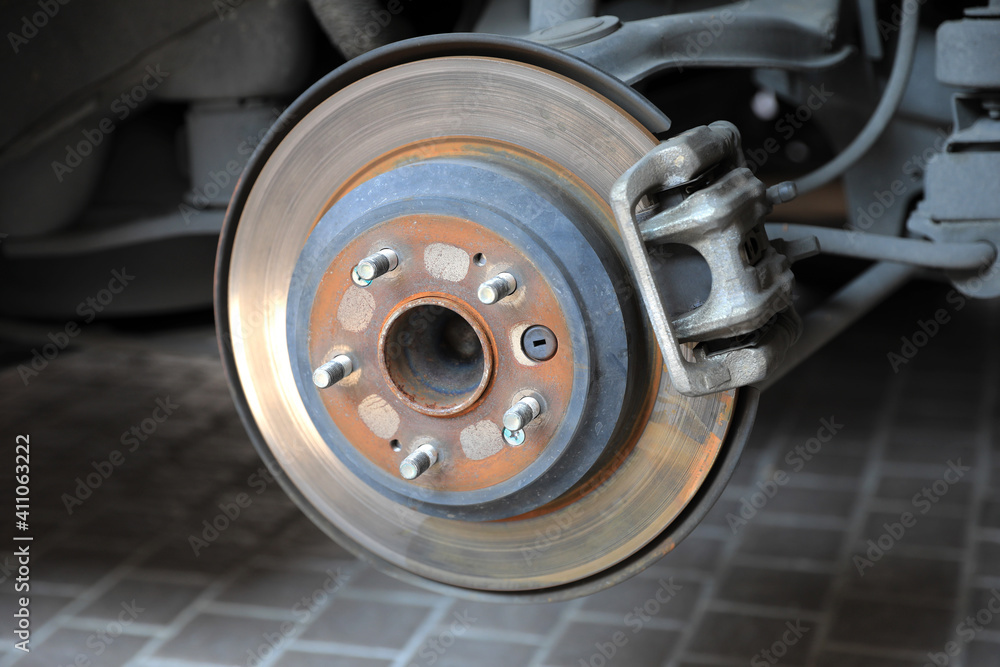 Disk brake and caliper in process of new tire replacement