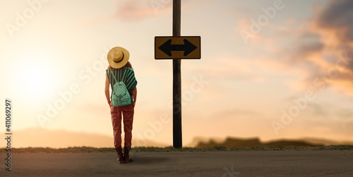 a backpacker woman traveler wondering for a way to go. photo