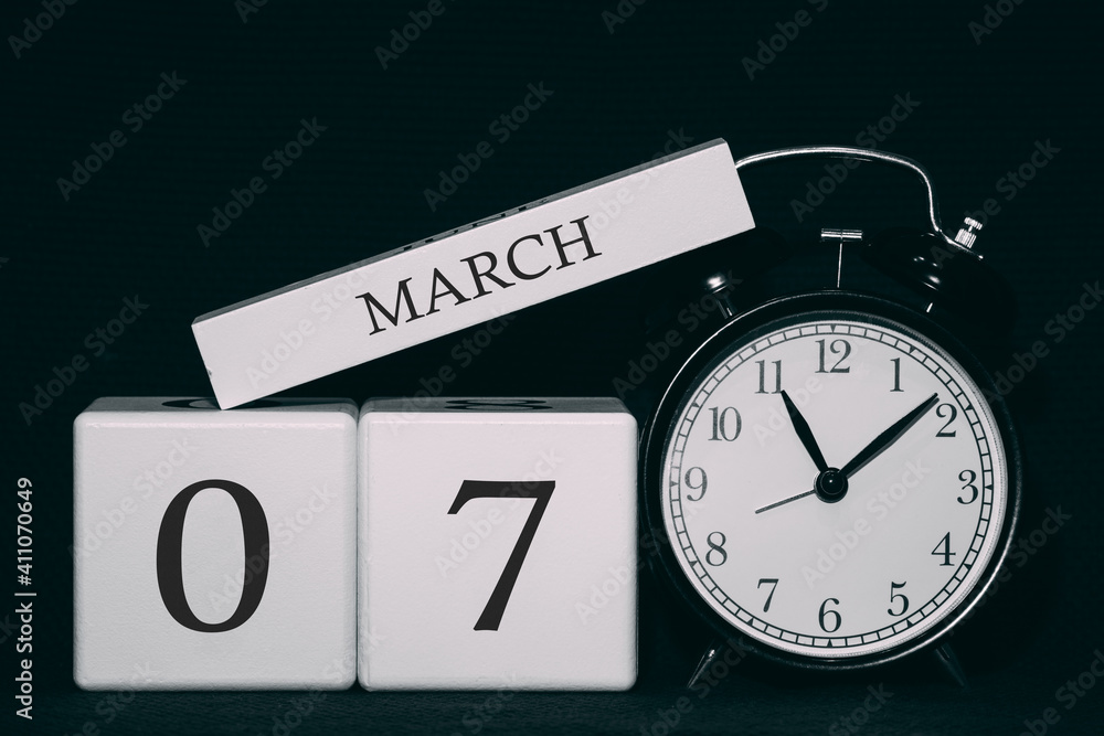 Important date and event on a black and white calendar. Cube date and month, day 7 March. Spring season. Important date and event on a black and white calendar. Cube date and month, day 7 March. Spring season.