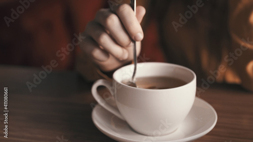Hot drink in white cup on tea party table rest